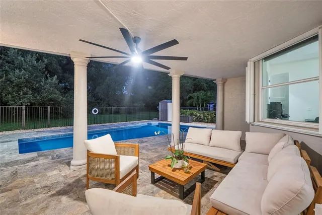 an aerial view of residential houses with outdoor space and trees