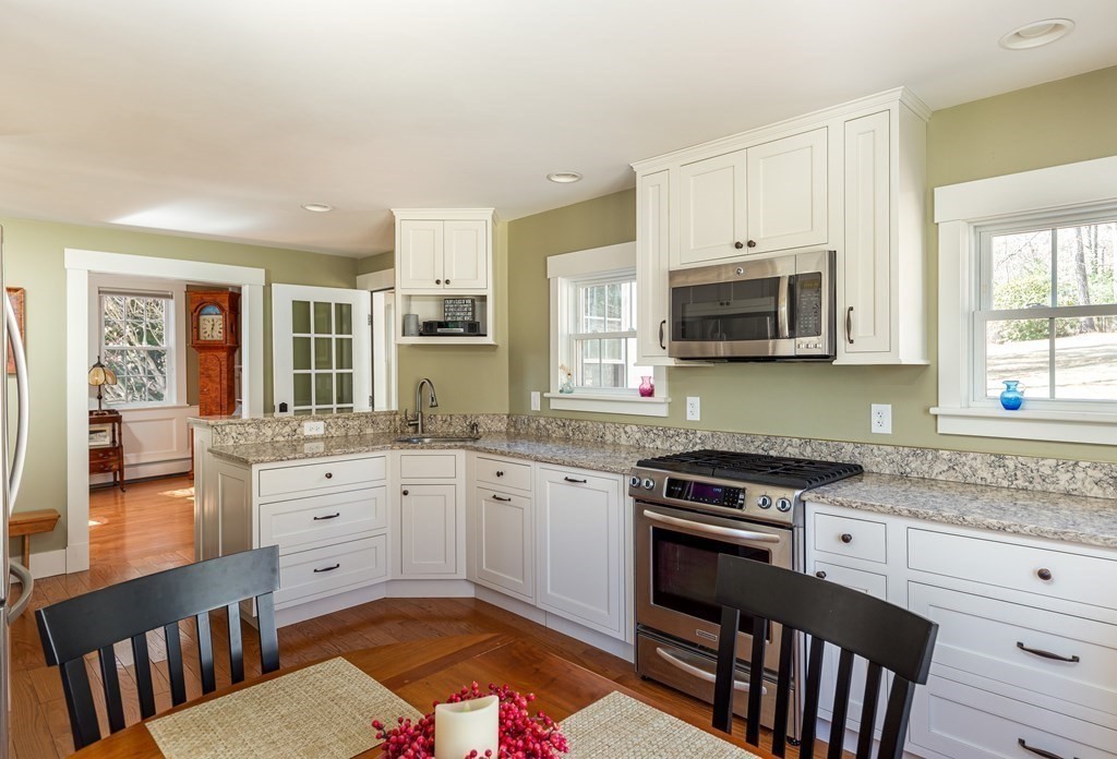 61 Ayer Road Harvard, MA 01451 - Photo 11 of 32 a kitchen with granite countertop a stove top oven sink and cabinets