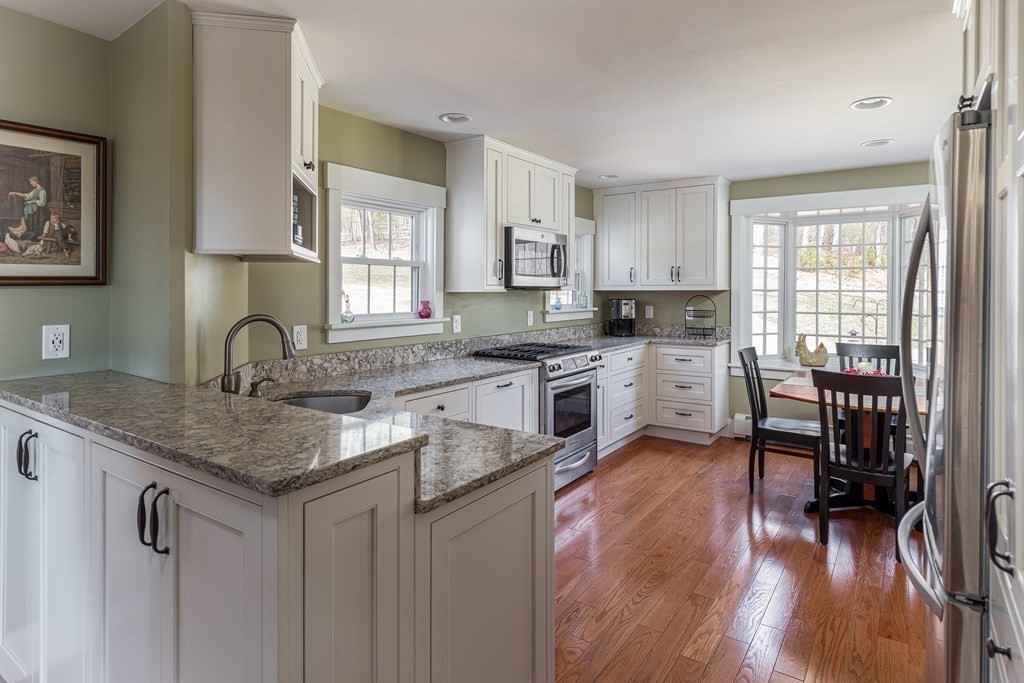 61 Ayer Road Harvard, MA 01451 - Photo 12 of 32 a kitchen with granite countertop a sink cabinets and wooden floor