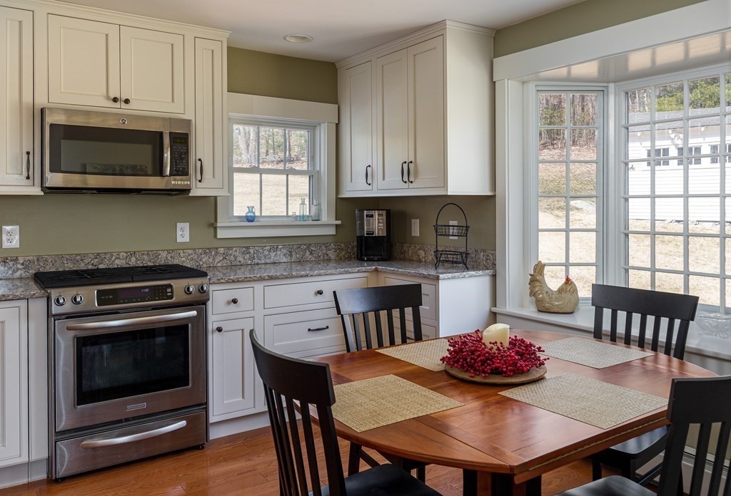61 Ayer Road Harvard, MA 01451 - Photo 14 of 32 a kitchen with stainless steel appliances a dining table and chairs