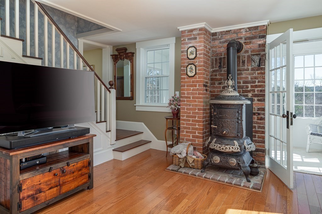 61 Ayer Road Harvard, MA 01451 - Photo 23 of 32 a living room with furniture a flat screen tv and a fireplace