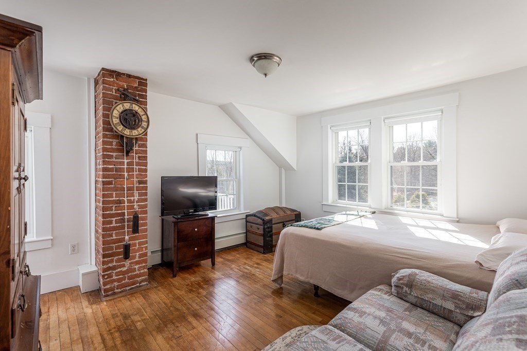 61 Ayer Road Harvard, MA 01451 - Photo 25 of 32 a bedroom with a bed furniture and a flat tv screen