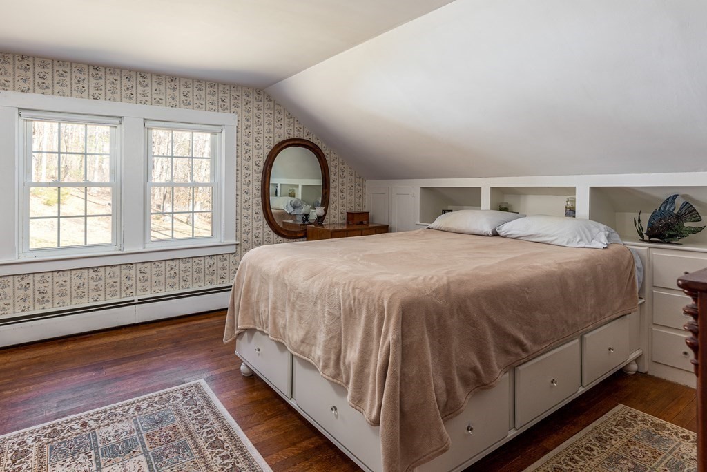 61 Ayer Road Harvard, MA 01451 - Photo 27 of 32 a bed sitting in a bedroom next to a window