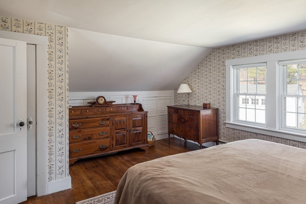 61 Ayer Road Harvard, MA 01451 - Photo 28 of 32 a bedroom with a bed and wooden floor