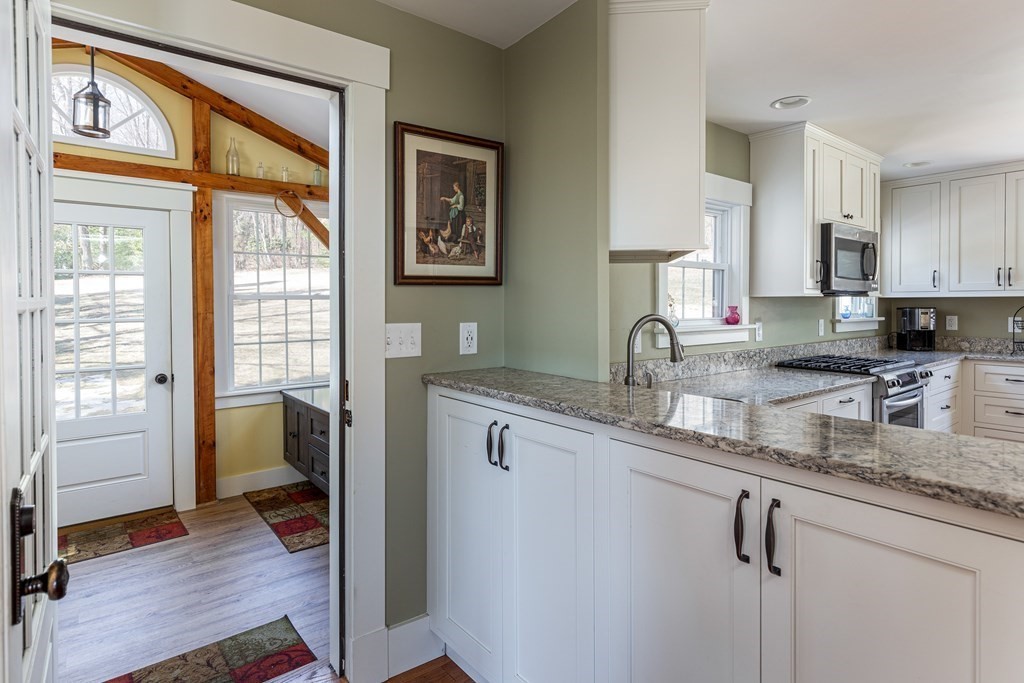 61 Ayer Road Harvard, MA 01451 - Photo 10 of 32 a kitchen with sink cabinets and wooden floor