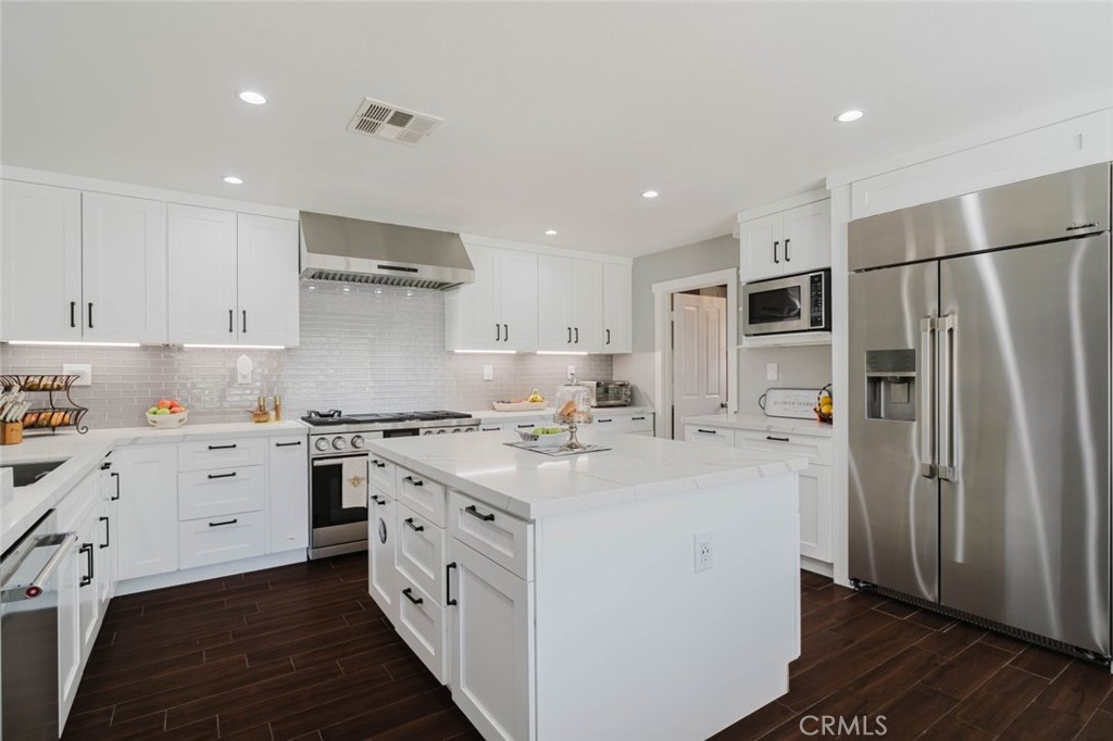 32480 The Old Road Castaic, CA 91384 - Photo 21 of 68 a kitchen with white cabinets and stainless steel appliances