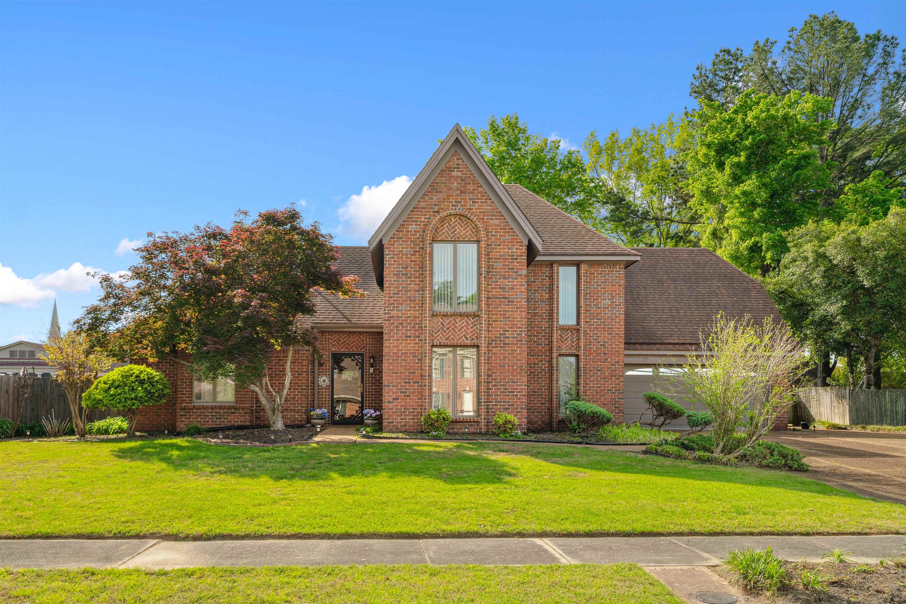 7063 Cutter Mill Road Memphis, TN 38141 - Photo 1 of 29 View of front of home featuring brick siding, fence, and a shingled roof