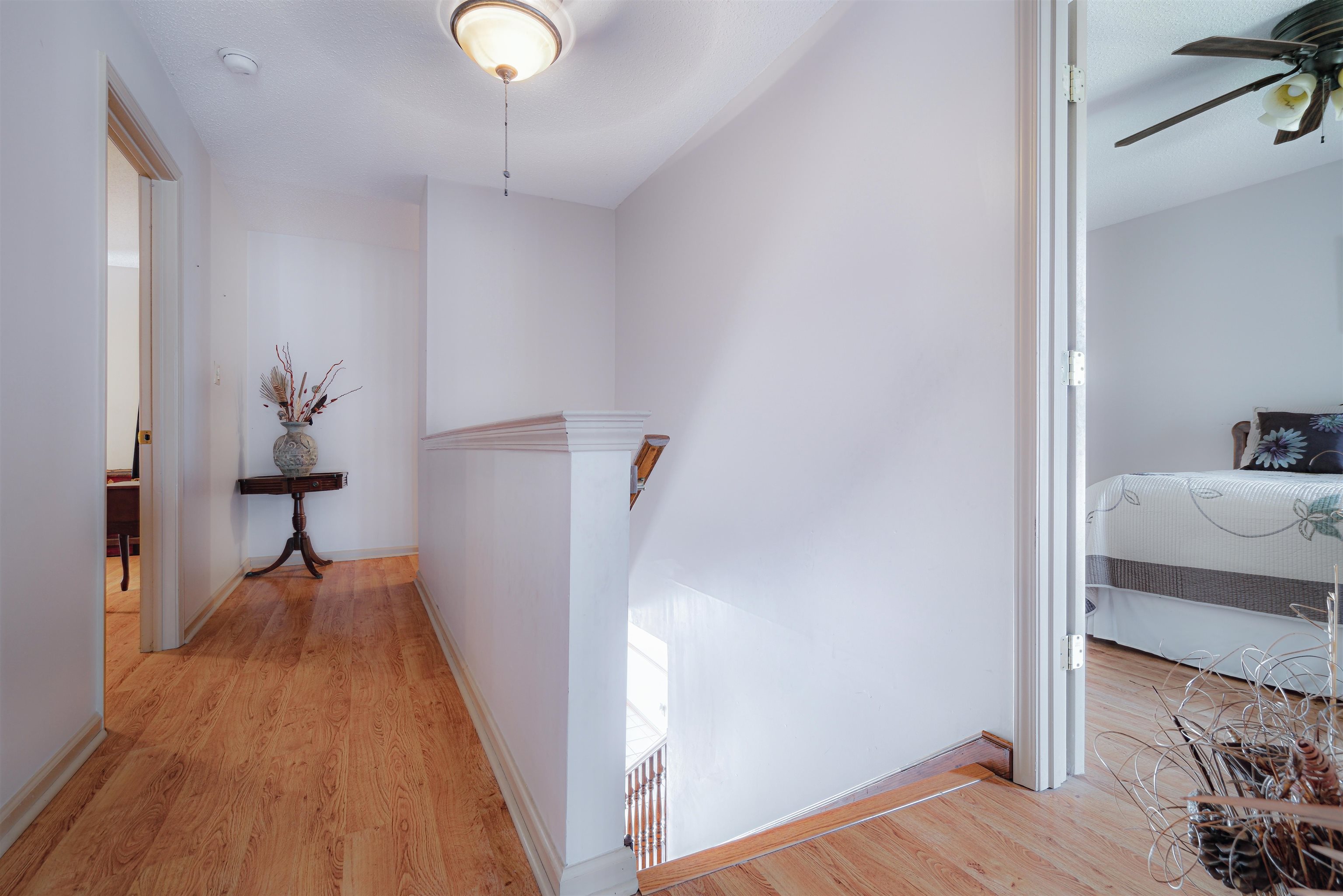 7063 Cutter Mill Road Memphis, TN 38141 - Photo 11 of 29 Corridor with light wood-style flooring, baseboards, and an upstairs landing