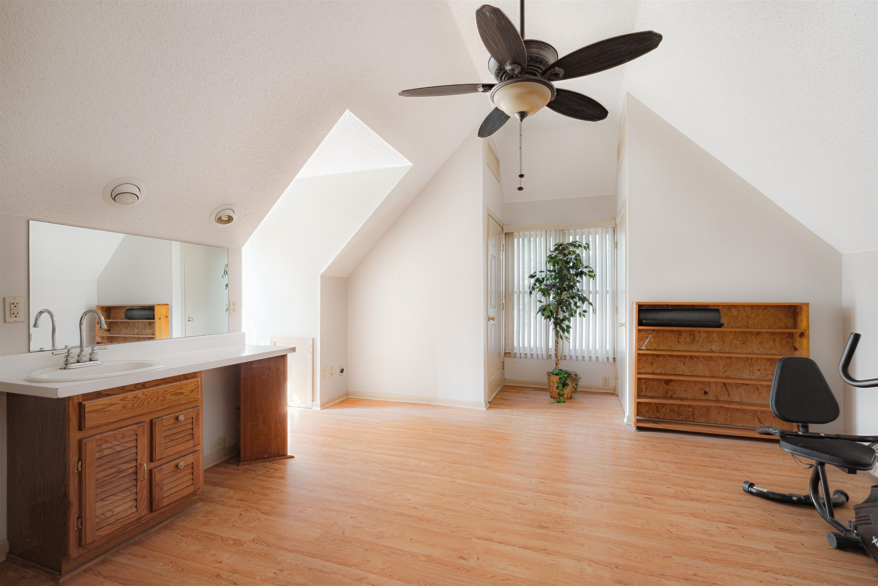 7063 Cutter Mill Road Memphis, TN 38141 - Photo 16 of 29 Bedroom featuring vaulted ceiling, ceiling fan, light wood-type flooring, stairs to private exit. Bathroom.