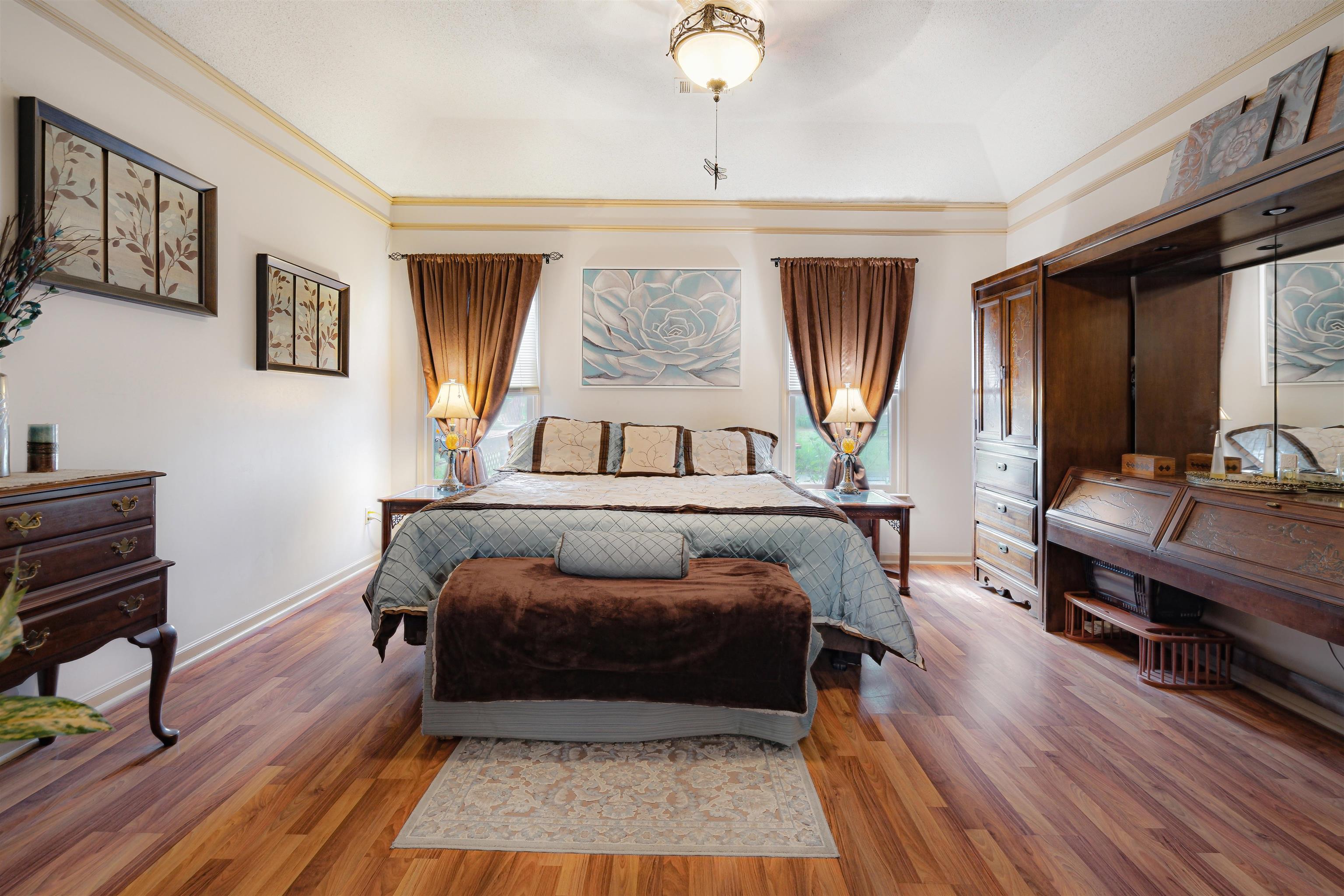 7063 Cutter Mill Road Memphis, TN 38141 - Photo 17 of 29 Spacious Bedroom featuring baseboards, crown molding, and wood finished floors