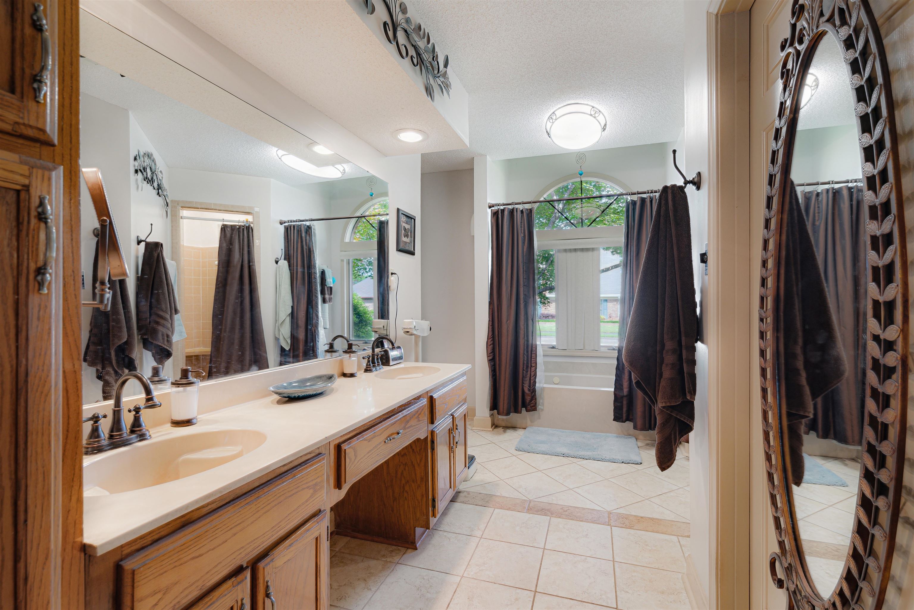7063 Cutter Mill Road Memphis, TN 38141 - Photo 18 of 29 Bright and spacious masterl bath with tile patterned floors, textured ceiling, and double vanity