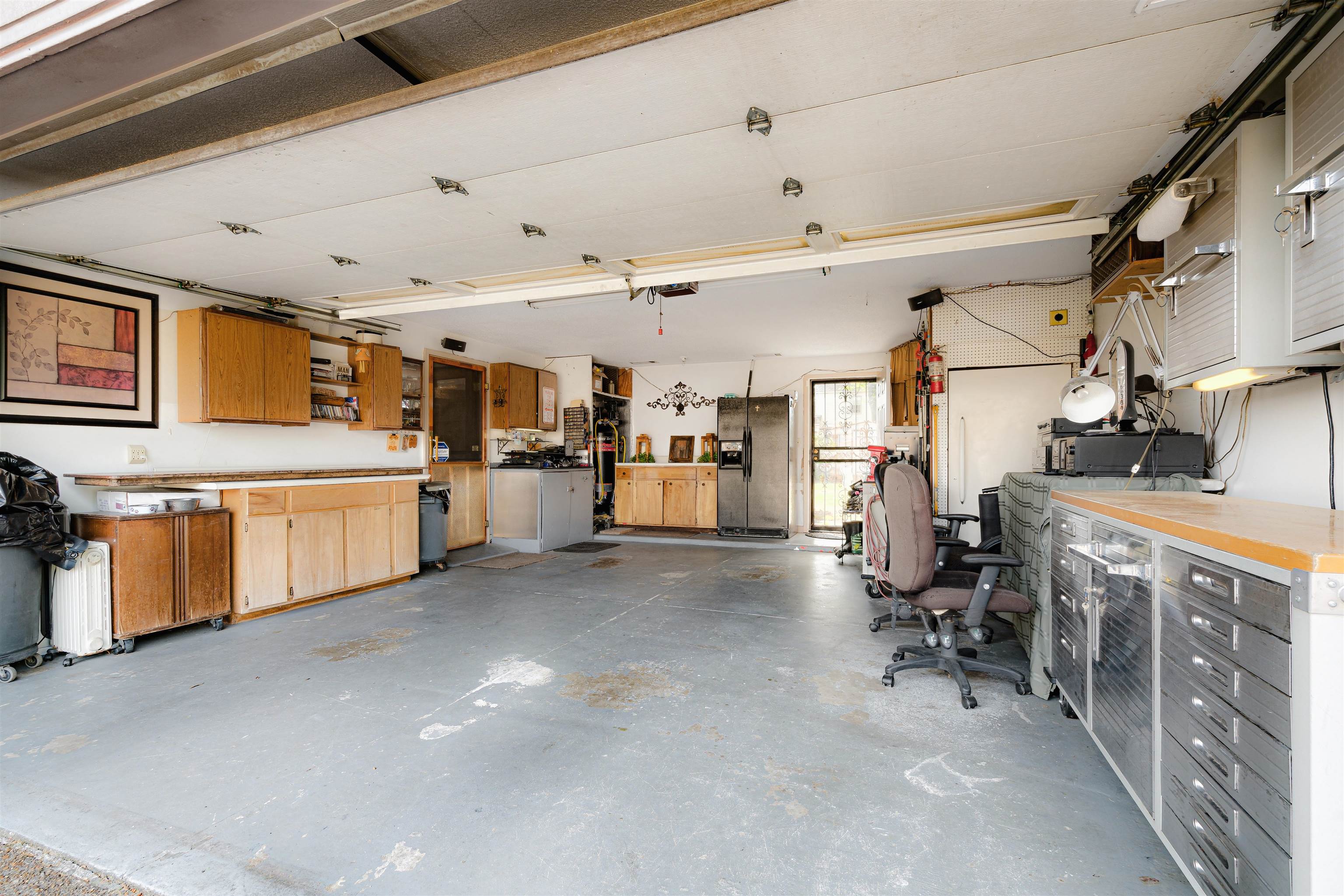 7063 Cutter Mill Road Memphis, TN 38141 - Photo 24 of 29 Garage featuring black refrigerator with ice dispenser and a workshop area
