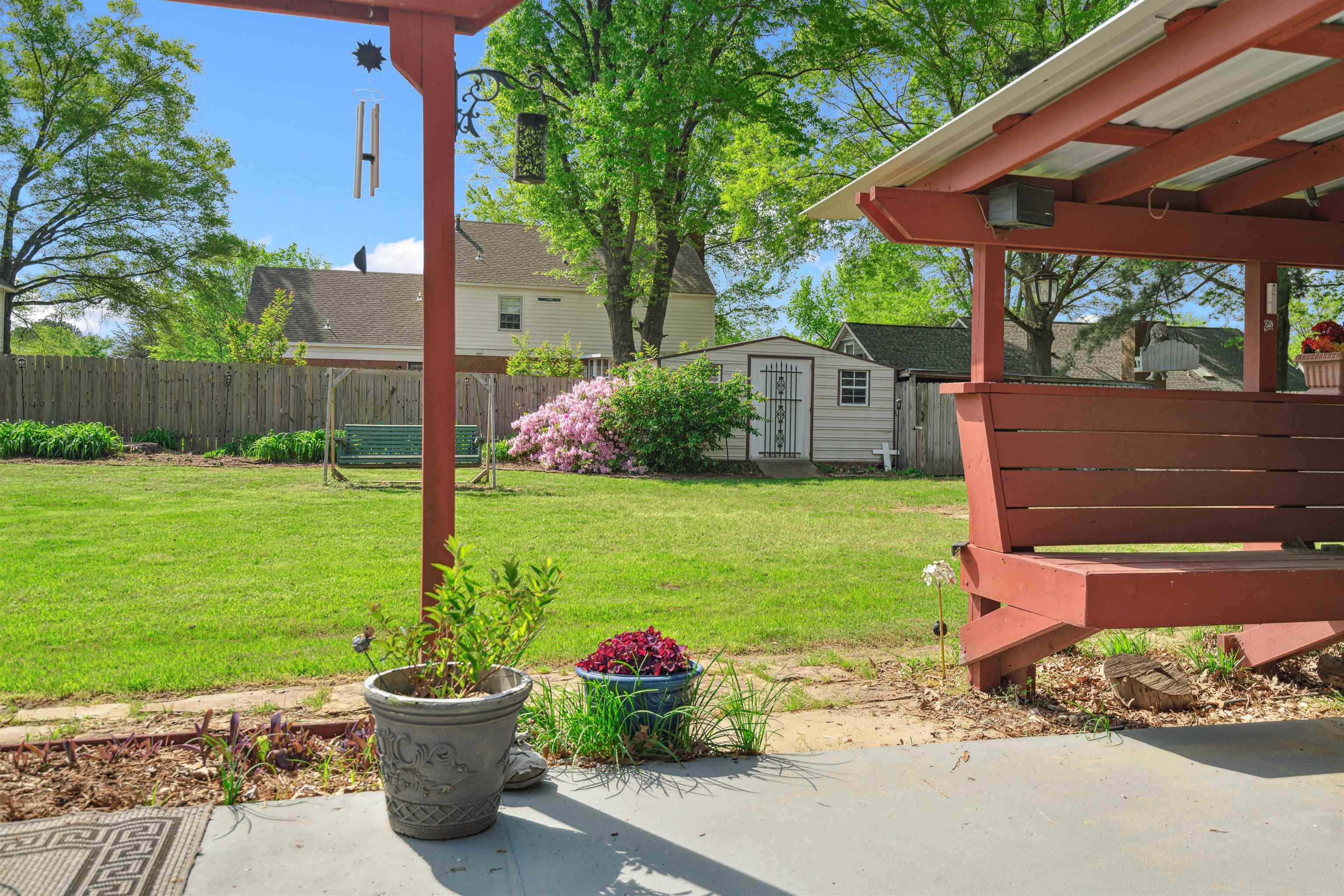 7063 Cutter Mill Road Memphis, TN 38141 - Photo 26 of 29 View of yard featuring a fenced backyard, an outdoor structure, a patio area, and a storage unit