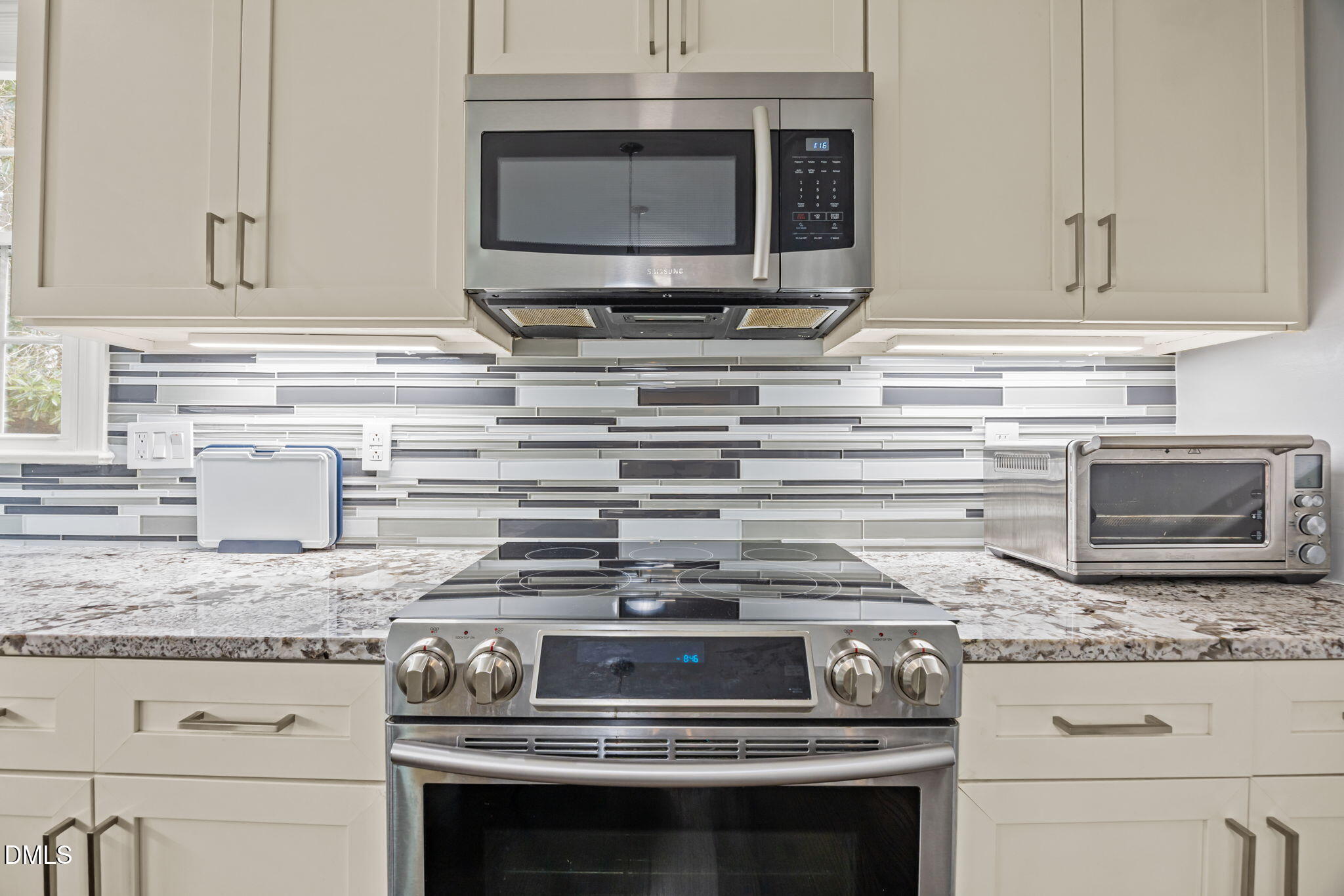 6313 Ashley Ridge Drive Raleigh, NC 27612 - Photo 12 of 41 a kitchen with granite countertop a stove microwave and sink