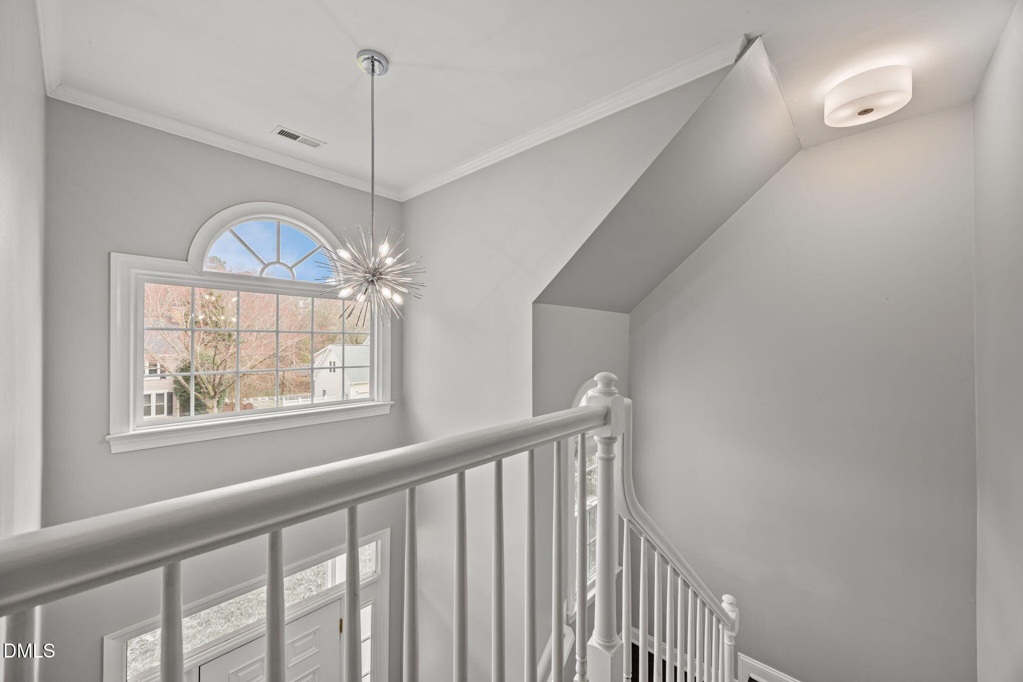 6313 Ashley Ridge Drive Raleigh, NC 27612 - Photo 18 of 41 a view of a hallway with windows and chandelier