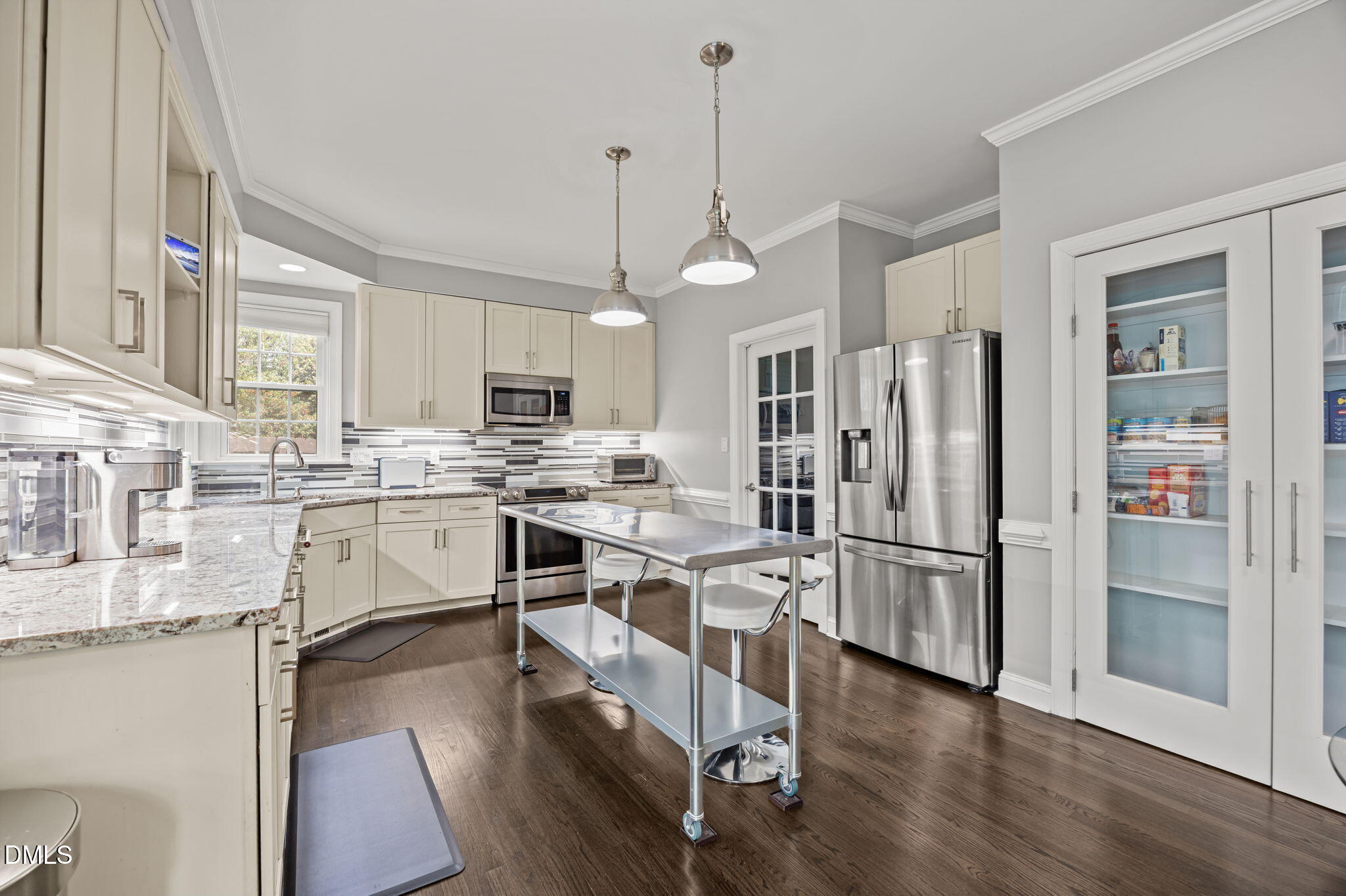 6313 Ashley Ridge Drive Raleigh, NC 27612 - Photo 8 of 41 a kitchen with stainless steel appliances kitchen island granite countertop a refrigerator a stove a sink and white cabinets with wooden floor