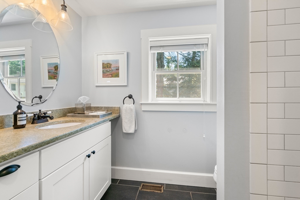 36 Autumn Circle Canton, MA 02021 - Photo 14 of 32 a bathroom with a granite countertop sink a mirror and a shower