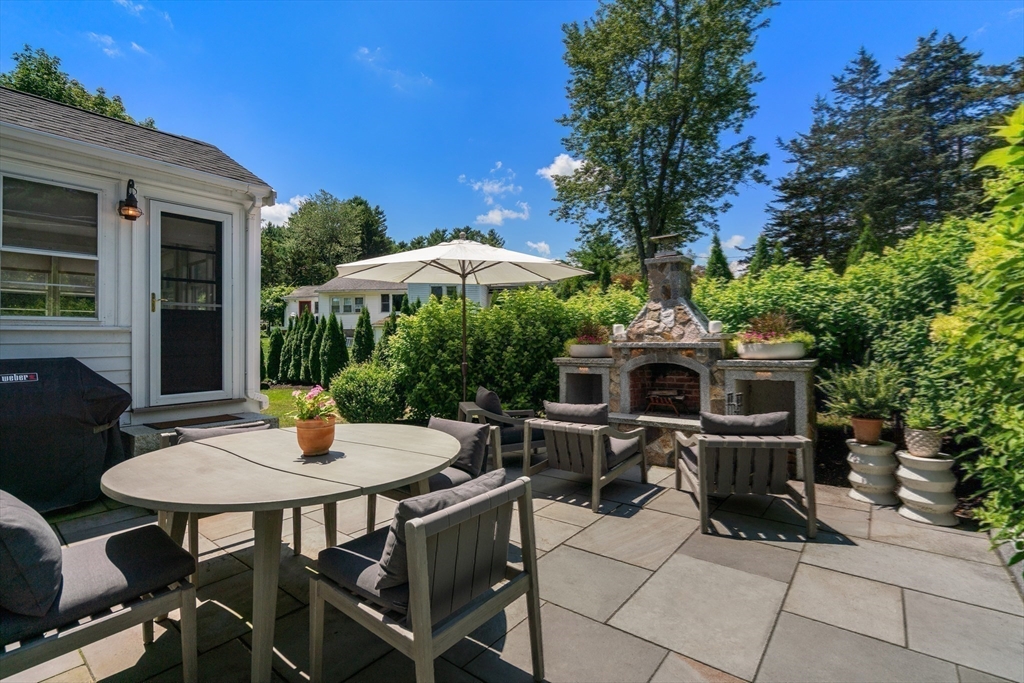 36 Autumn Circle Canton, MA 02021 - Photo 26 of 32 a view of a patio with a table and chairs under an umbrella