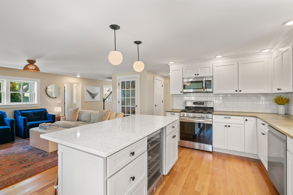36 Autumn Circle Canton, MA 02021 - Photo 5 of 32 a large kitchen with kitchen island a stove a sink a center island and wooden floor