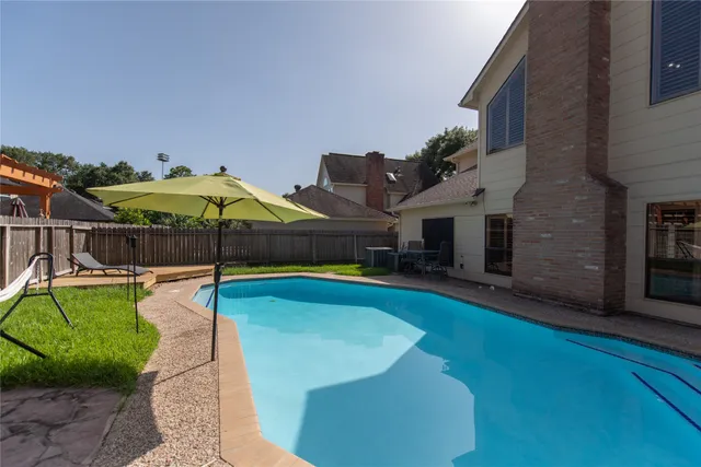 a view of a swimming pool with lounge chair