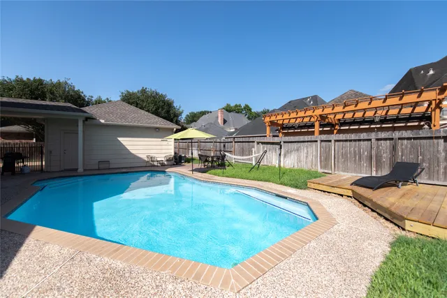 a view of a lake with a garden and wooden floor