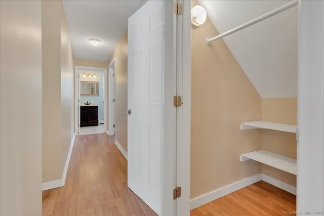 a view of a hallway with wooden floor and entryway