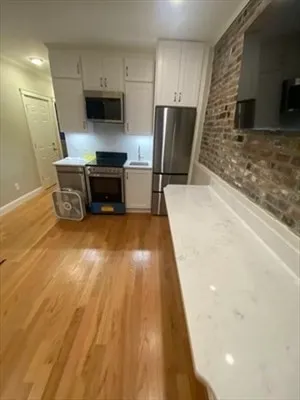 a kitchen with a sink and a refrigerator