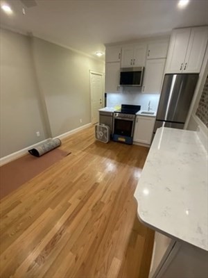 37 Garden Boston Ma, Unit 10 Boston, MA 02114 - Photo 3 of 10 a living room with furniture and a flat screen tv