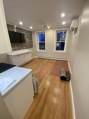 37 Garden Boston Ma, Unit 10 Boston, MA 02114 - Photo 4 of 10 a view of an empty room with wooden floor and a window