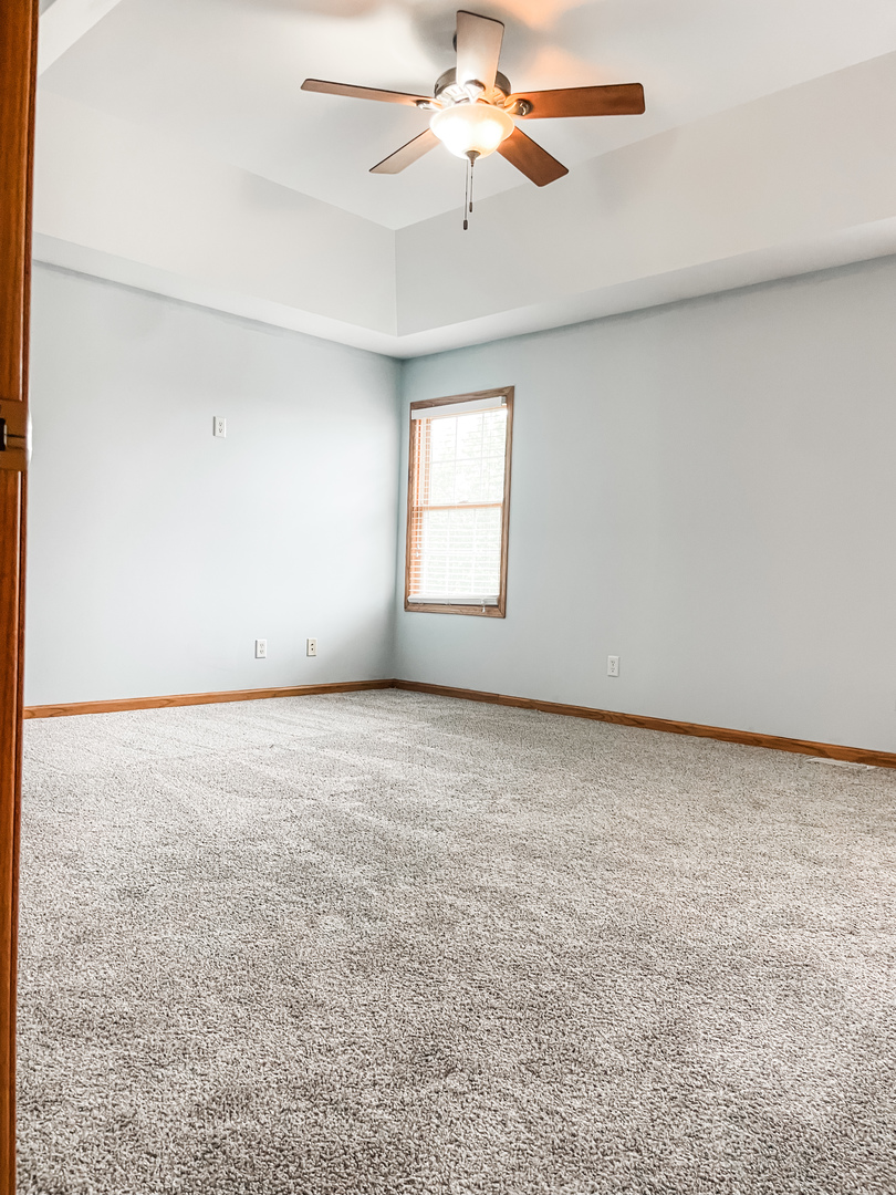 1308 Axcel Lane Sycamore, IL 60178 - Photo 23 of 40 an empty room with windows and fan