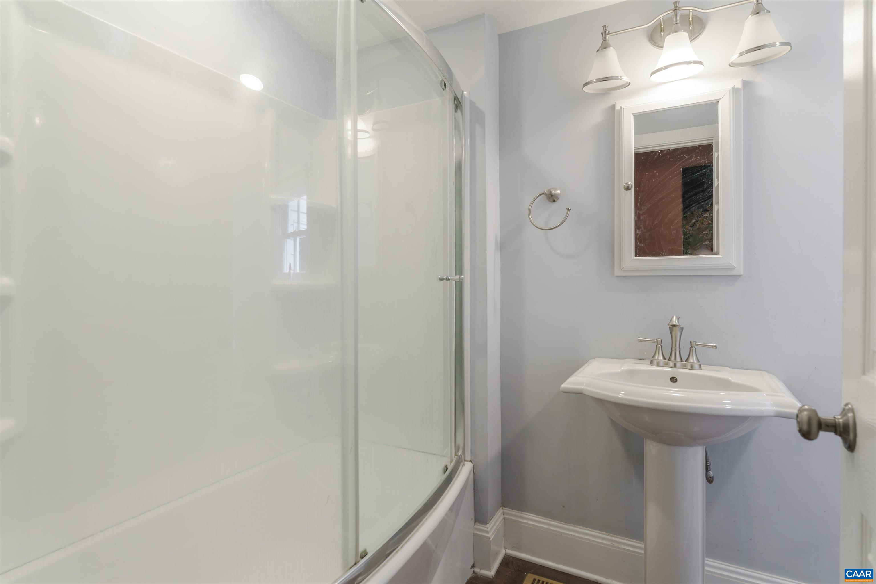 5515 Gordonsville Road Keswick, VA 22947 - Photo 18 of 46 a bathroom with a sink a mirror and shower