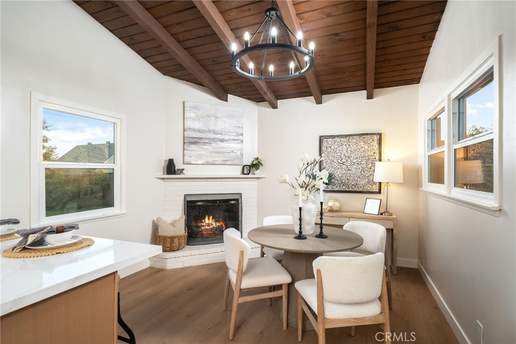 838 East Ada Avenue Glendora, CA 91741 - Photo 12 of 48 a dining room with wooden floor a chandelier a wooden table and chairs