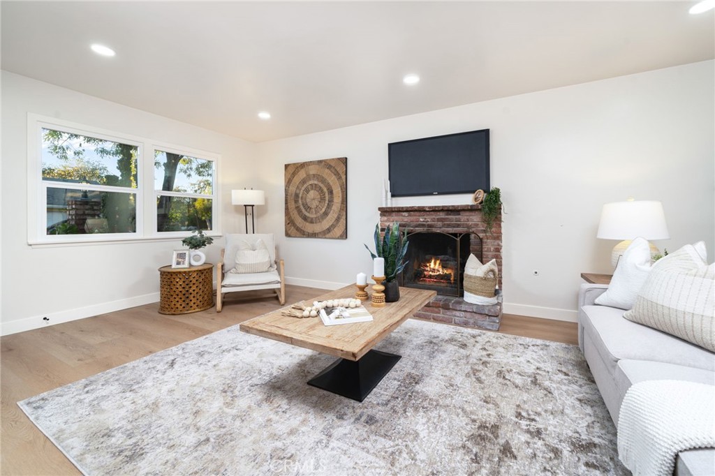 838 East Ada Avenue Glendora, CA 91741 - Photo 8 of 48 a living room with furniture a flat screen tv and a fireplace