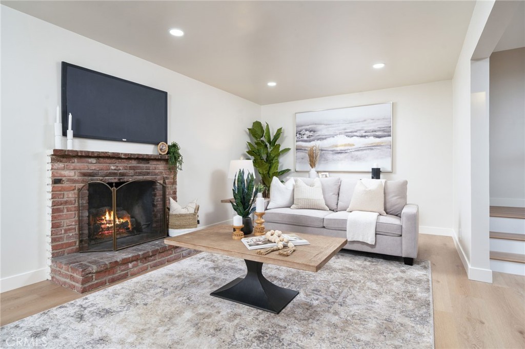 838 East Ada Avenue Glendora, CA 91741 - Photo 9 of 48 a living room with furniture a flat screen tv and a fireplace