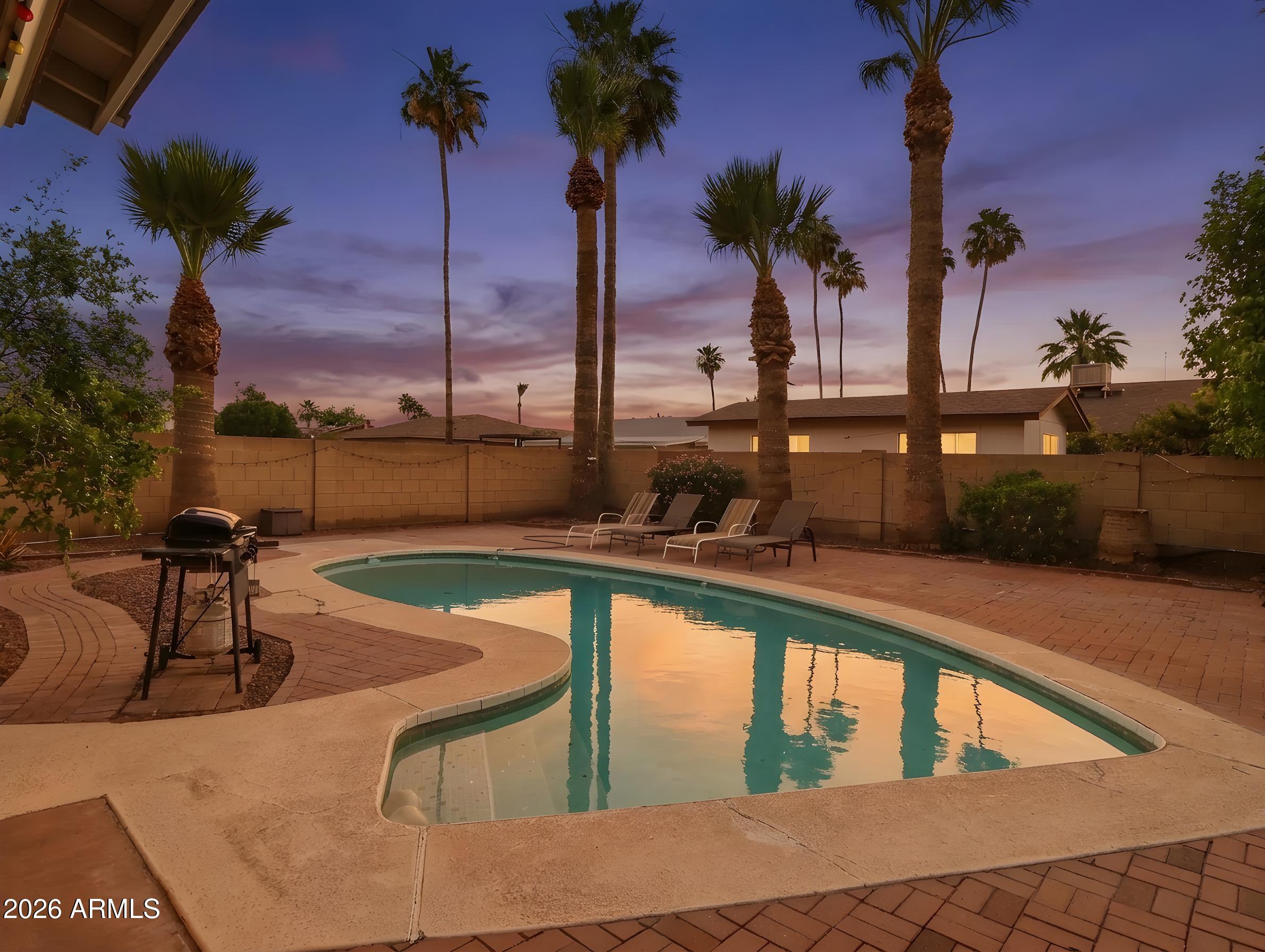 450 Cascada Road Litchfield Park, AZ 85340 - Photo 38 of 40 a view of a swimming pool with a lounge chairs