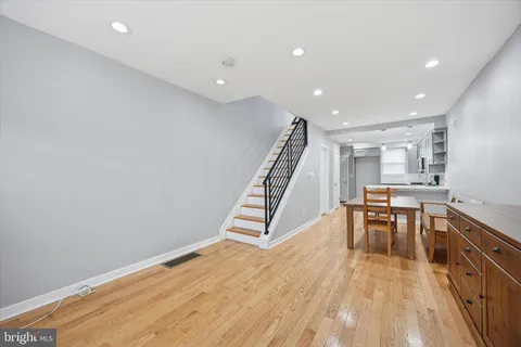 a view of a kitchen with furniture and wooden floor
