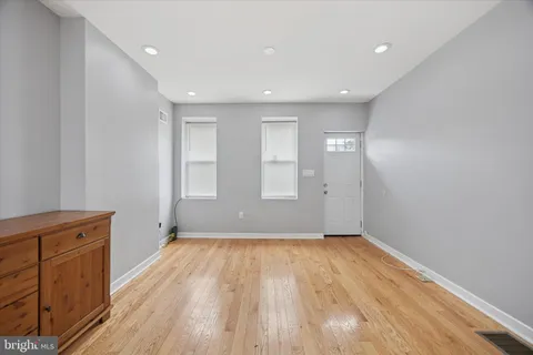a view of a room with wooden floor and window