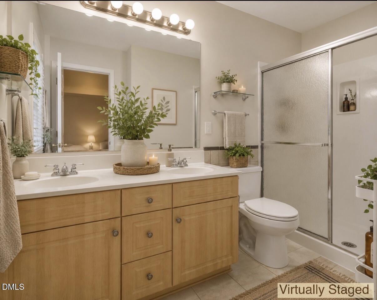 2907 Andover Glen Road Raleigh, NC 27604 - Photo 23 of 39 a bathroom with a double vanity sink toilet and shower