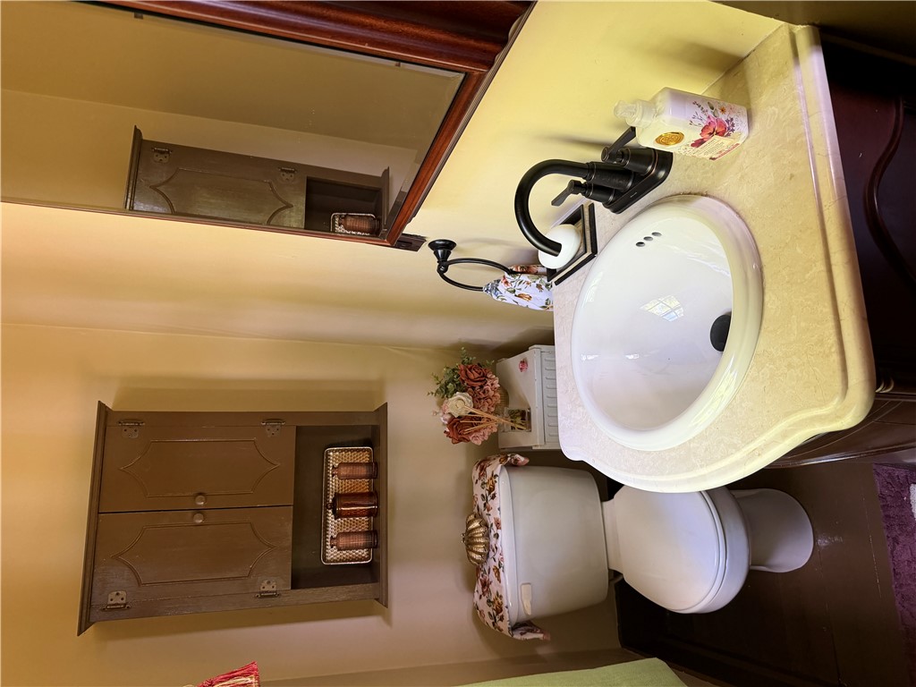 1100 Maple Calvert, TX 77837 - Photo 24 of 32 a bathroom with a sink and a toilet