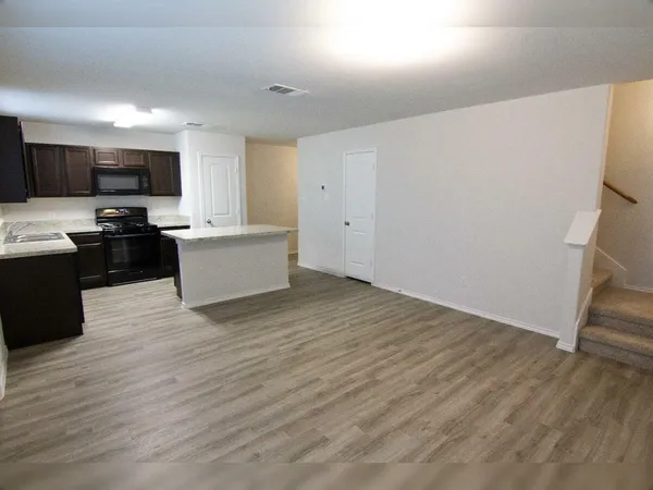 a view of a kitchen with microwave and cabinets