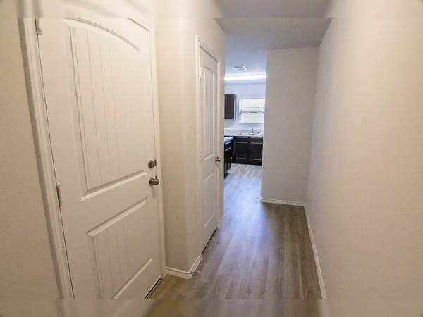 a view of a room with wooden floor