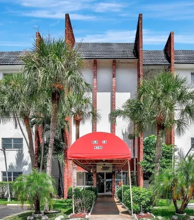 a large bed sitting in a bedroom next to a window with lamp