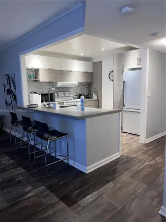 a bathroom with a sink vanity and mirror