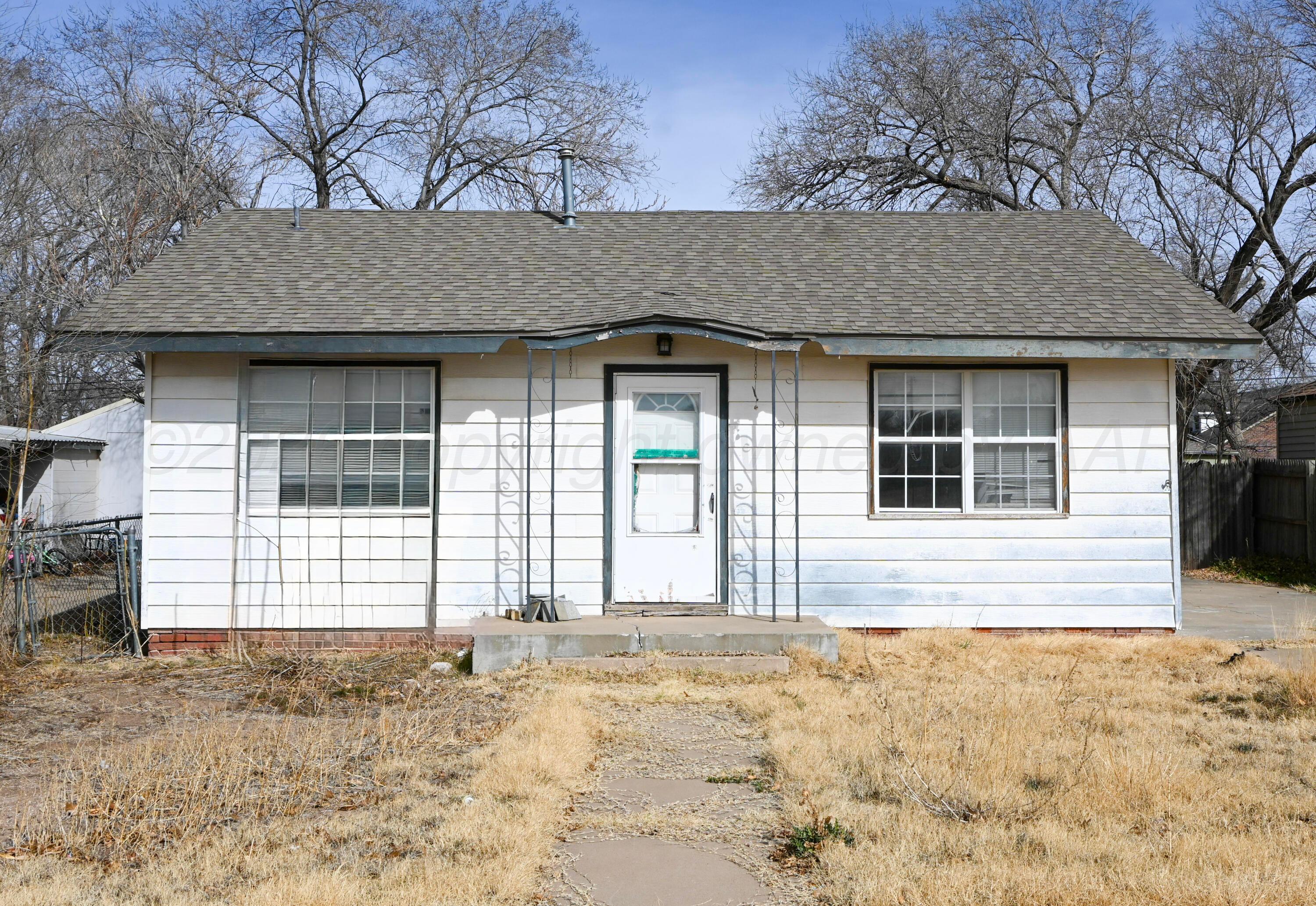 1210 Southwest 12th Avenue Amarillo, TX 79102 - Photo 1 of 12 a front view of a house with a yard and garage