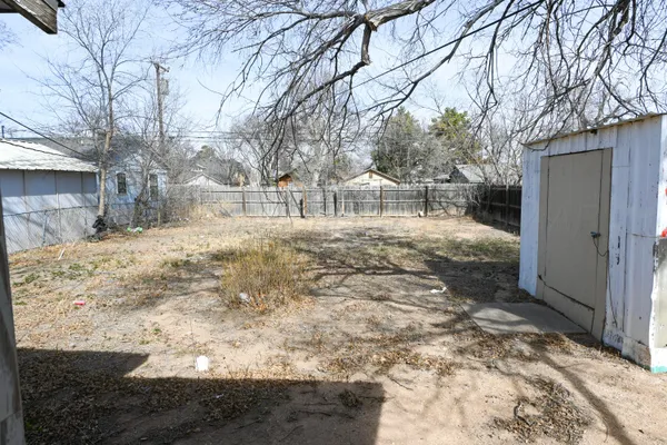 a view of yard covered with snow in front of house