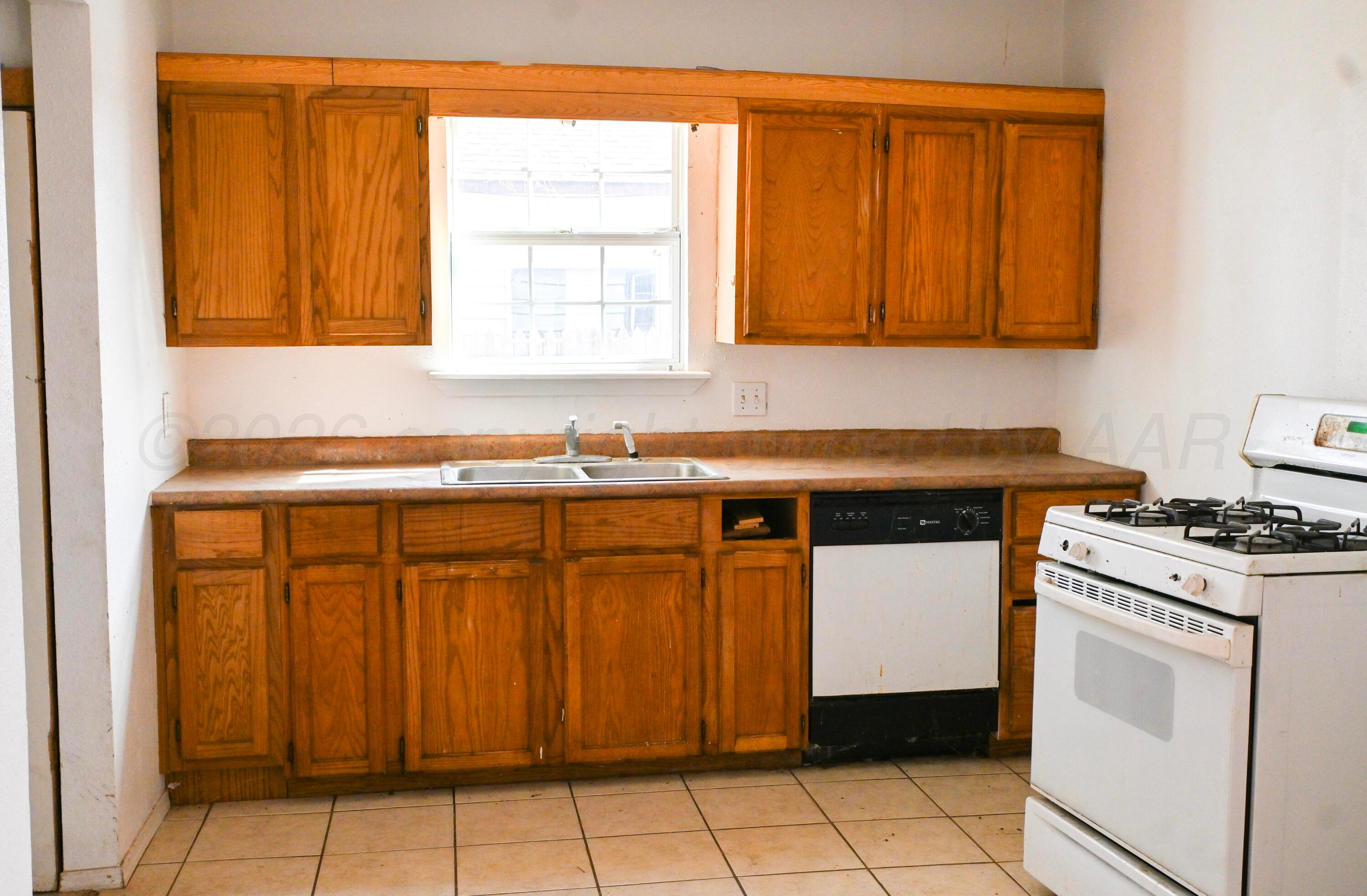 1210 Southwest 12th Avenue Amarillo, TX 79102 - Photo 3 of 12 a kitchen with stainless steel appliances a stove a sink and a cabinets