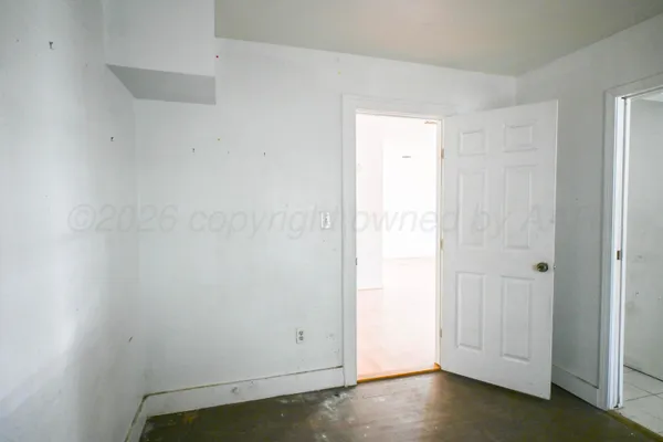 an empty room with closet area
