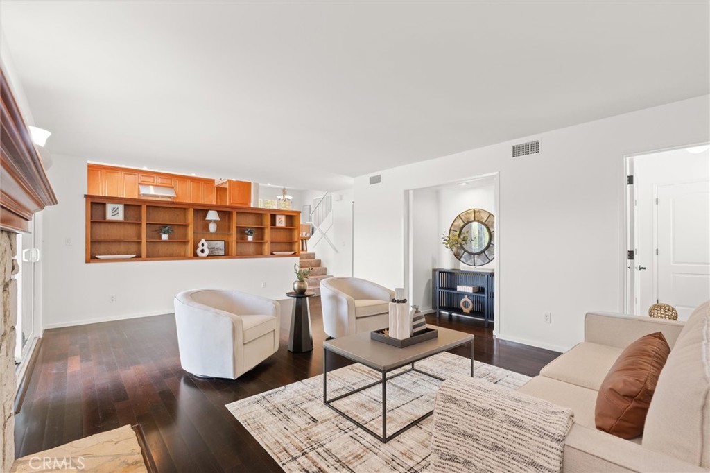 6301 East Bixby Hill Road Long Beach, CA 90815 - Photo 13 of 48 a living room with furniture a rug and a window