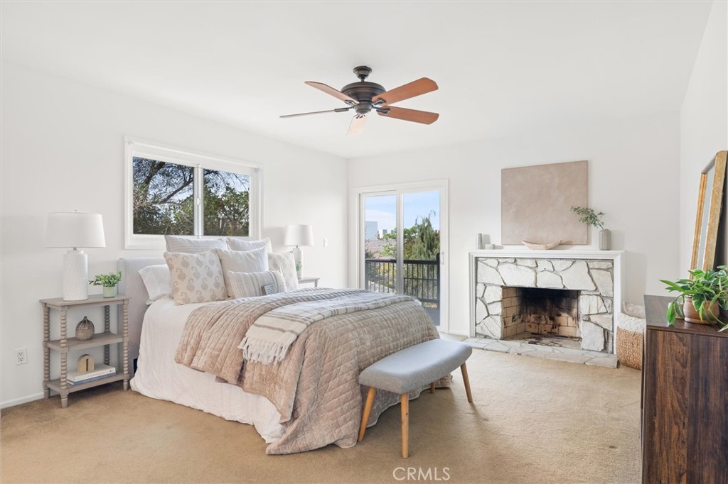 6301 East Bixby Hill Road Long Beach, CA 90815 - Photo 18 of 48 a bedroom with a bed and a fireplace