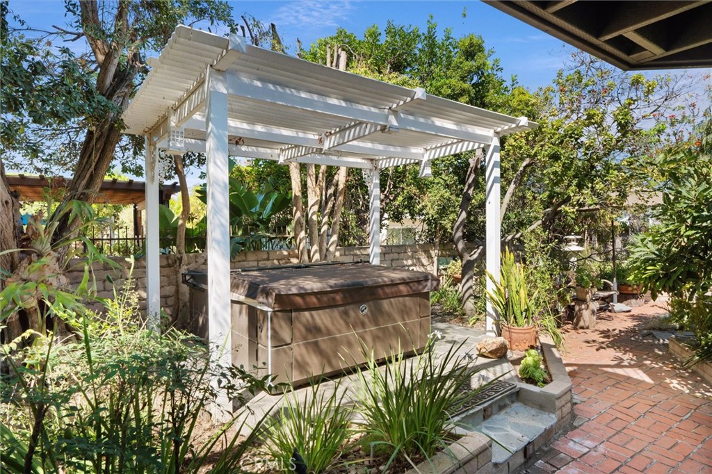 6301 East Bixby Hill Road Long Beach, CA 90815 - Photo 26 of 48 a view of a patio with table and chairs under an umbrella